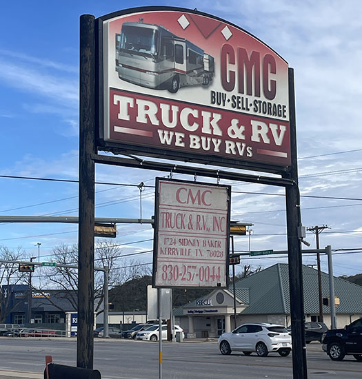 Sign for CMC Truck & RV, featuring services to buy and sell RVs, located in Kerrville, Texas, with contact information below.