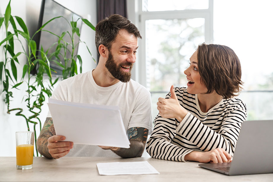 A happy couple reviewing RV sales financing options with excitement.